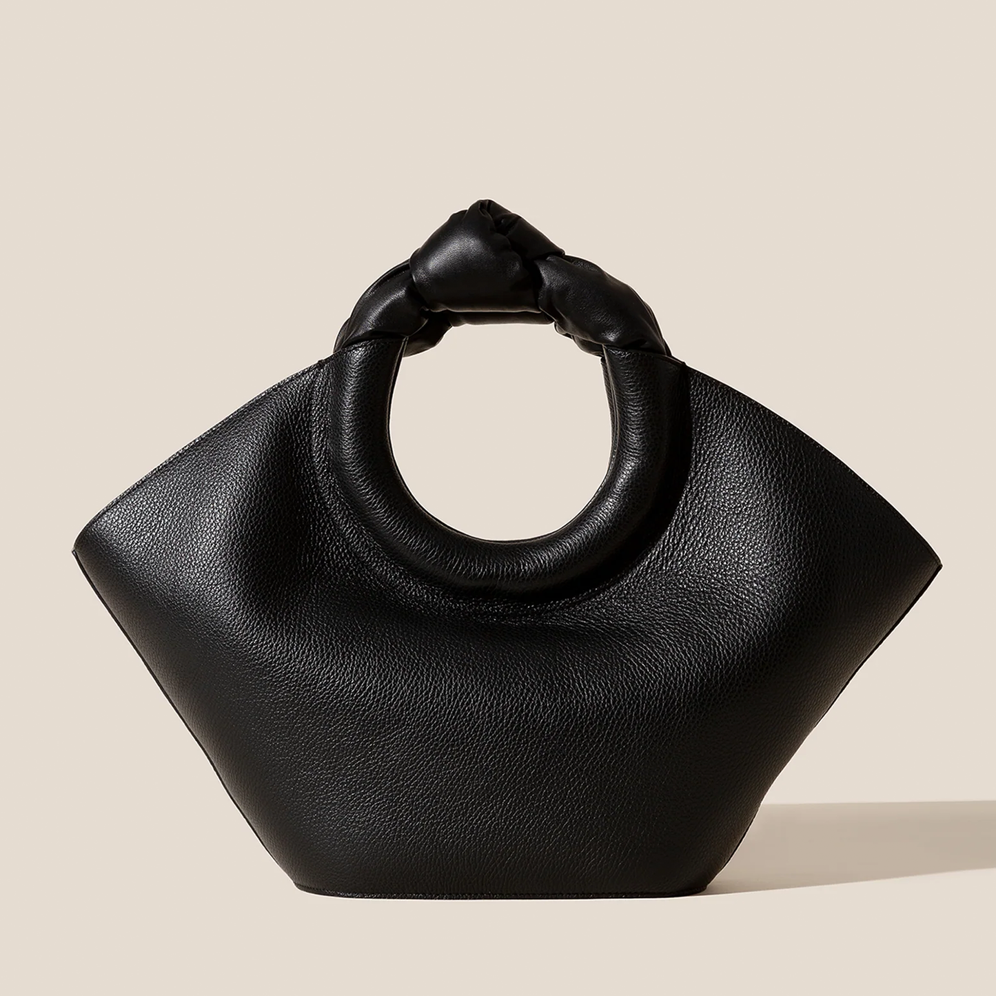 Solid Deep Black Pebbled Grain Wide Flared Carry Bag With Sculpted Knotted Circular Top Grip And Ruched Fabric Inner Storage Insert