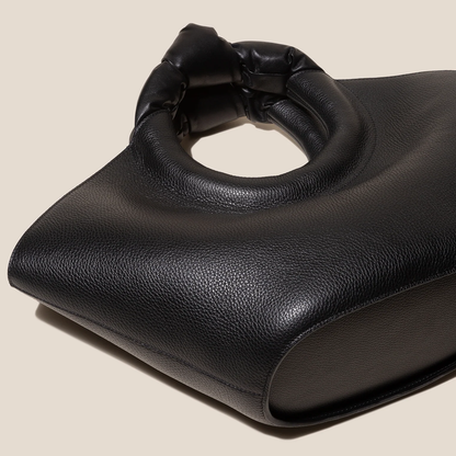 Solid Deep Black Pebbled Grain Wide Flared Carry Bag With Sculpted Knotted Circular Top Grip And Ruched Fabric Inner Storage Insert