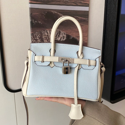 Mist Light Blue Pebbled Grain Dual-Tone Compact Trapezoid Hand Tote With Creamy Off-White Trim And Sleek Silvery Twist Lock Hardware Tag